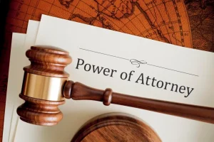 A gavel and some papers on top of a table.